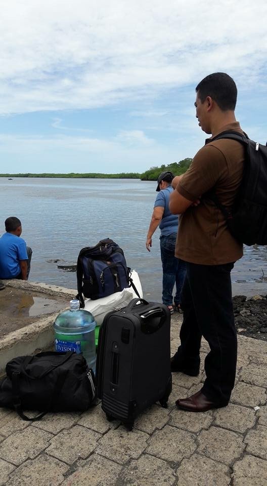 Brother Cecilio Hernandez, O. Carm., waits with others for the boat to Jobal.