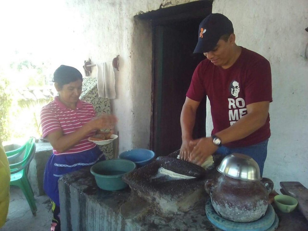 Brother Cecilo Hernandez, O. Carm., and a parishioner prepare a meal together.