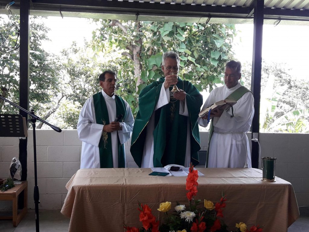 Three priests administering the Eucharist
