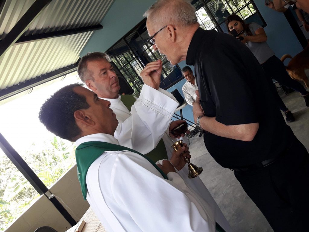 Priest distributes communion