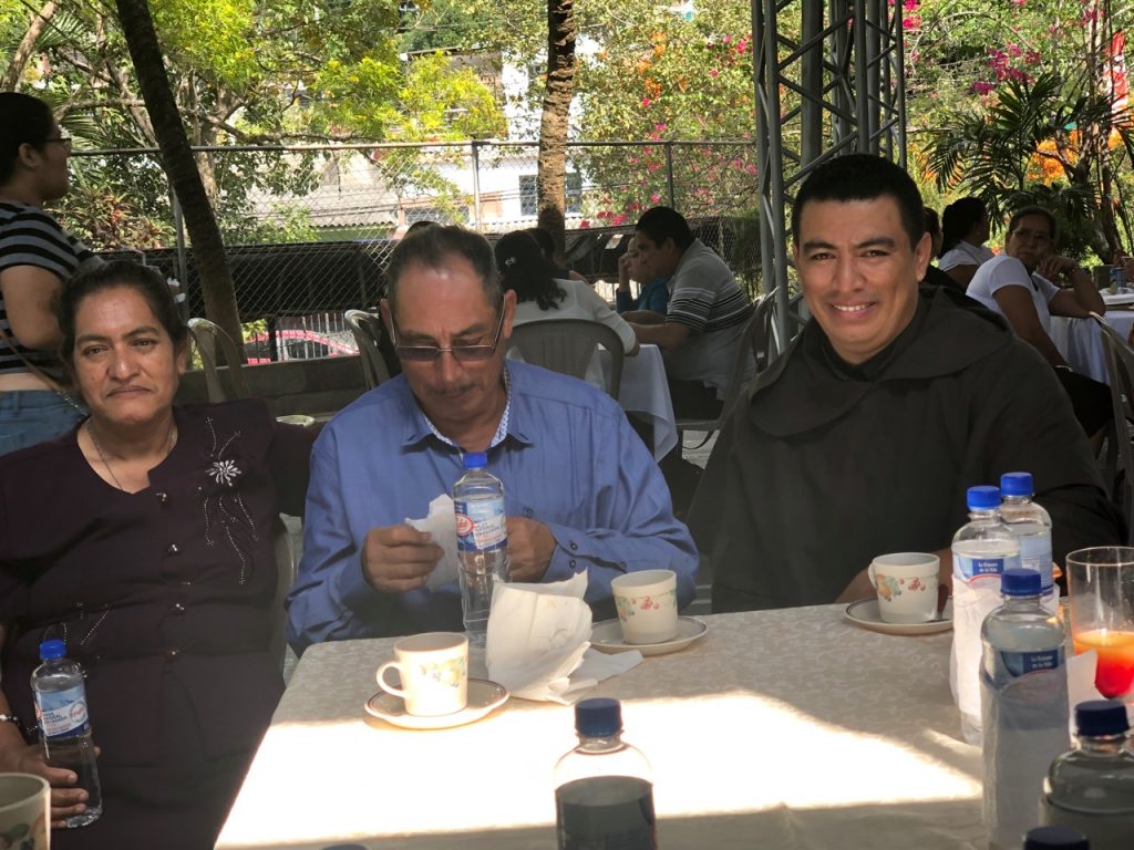 The newly ordained and his parents, Santos and Olivia, enjoy some Cafe Carmelita following a delicious meal offered by the Discalced Carmelite sisters who hosted the ordination in their school chapel.