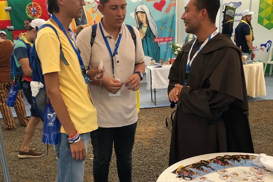 Br. Aristides Menjivar, O. Carm., speaks with two young men about the Carmelites during on of the many opportunities the young people had to learn more about the religious orders that were present at the 2019 World Youth Day.