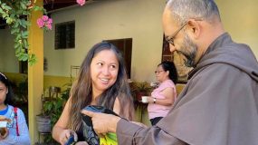 El Salvadoran parishoner chats with one of the Carmelite priests at the Saturday Hospitality ministry